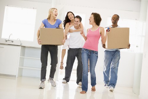 Moving team handling boxes and furniture carefully in a local relocation service