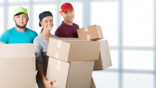 Catford property move with movers carrying items through a shared entrance