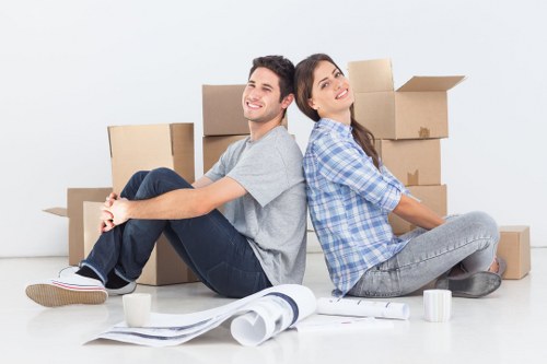 Local movers preparing boxes in a Catford property