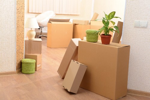 Packed boxes and wrapped furniture prepared for a Catford apartment removal
